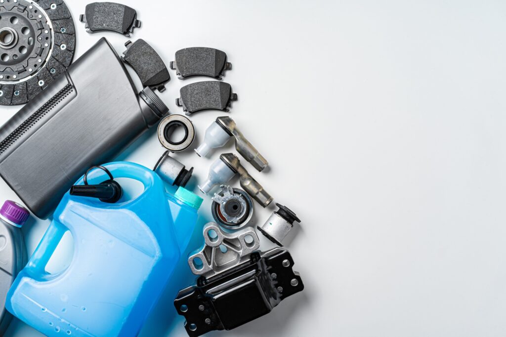 New metal auto parts on grey background