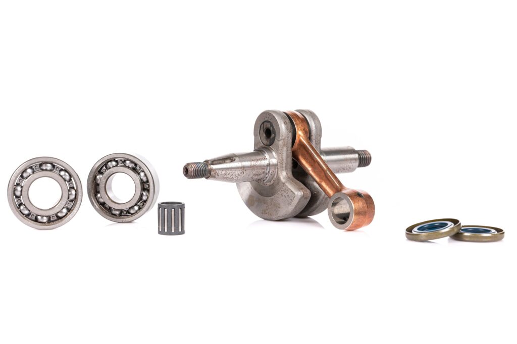 set of auto parts with a crankshaft for a petrol mower on a white isolated background
